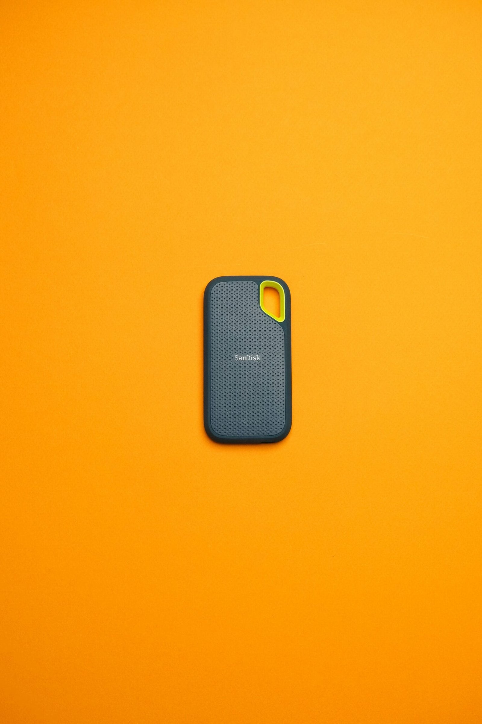 A cell phone sitting on top of a yellow surface