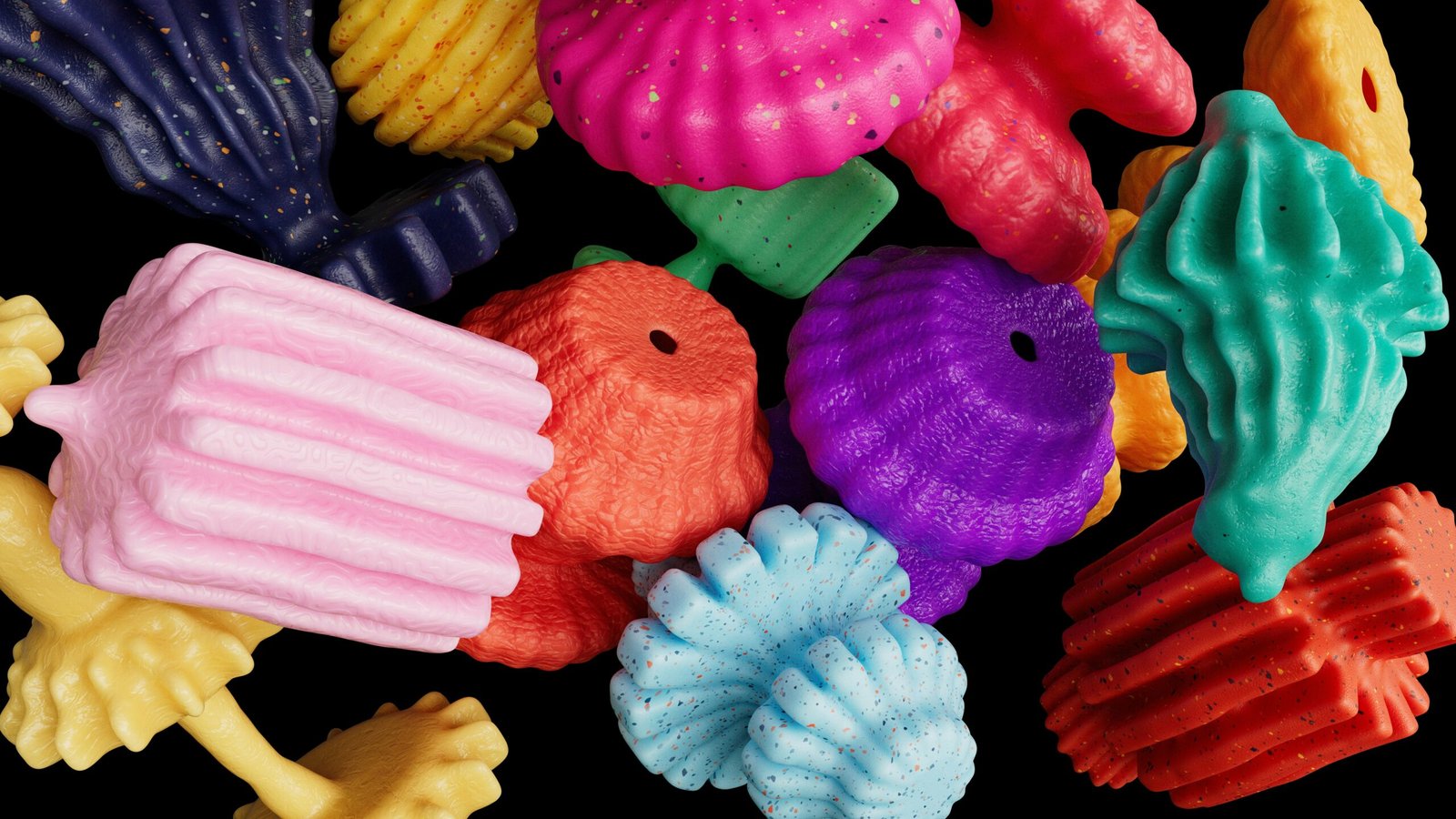 Colorful plastic shapes scattered against a dark background.
