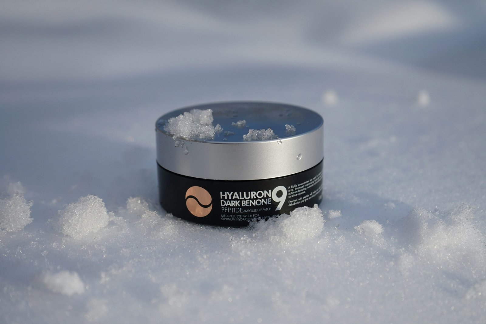 a jar of snow sits in the middle of a pile of snow